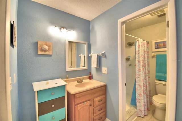 bathroom with a shower with curtain, tile patterned flooring, a textured ceiling, toilet, and vanity