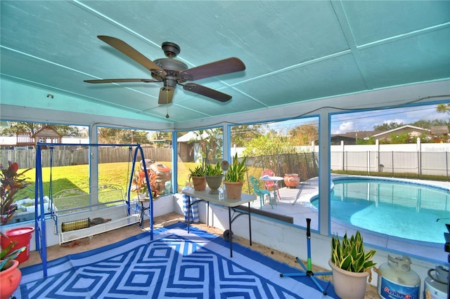 unfurnished sunroom featuring ceiling fan and vaulted ceiling