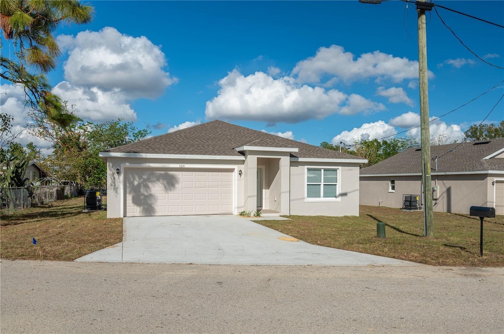 view of front of home featuring a garage and a front lawn