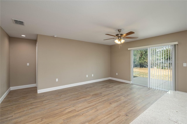 empty room with light hardwood / wood-style flooring and ceiling fan