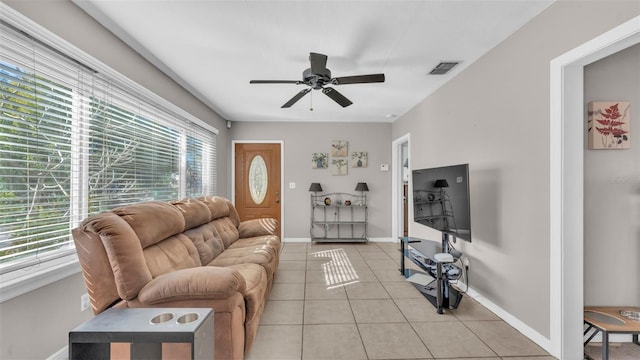 living room featuring ceiling fan, a healthy amount of sunlight, and light tile patterned floors