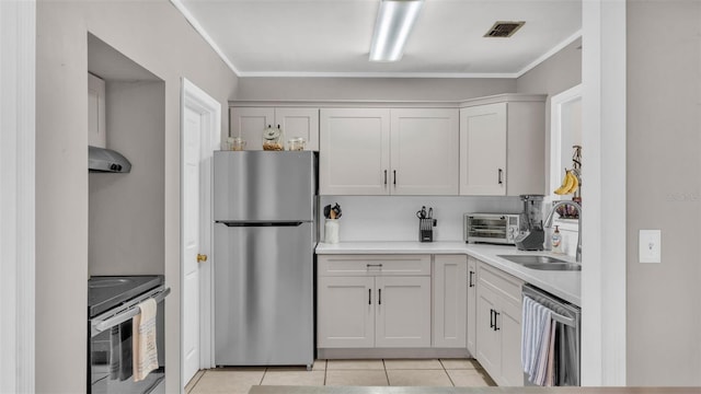 kitchen featuring light tile patterned flooring, extractor fan, sink, stainless steel appliances, and white cabinets