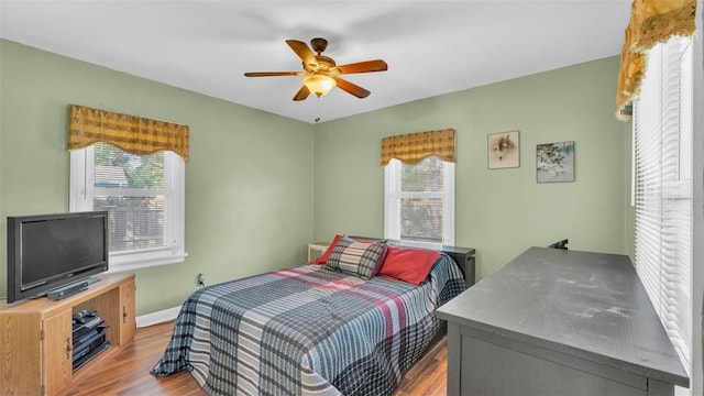 bedroom with ceiling fan and light wood-type flooring