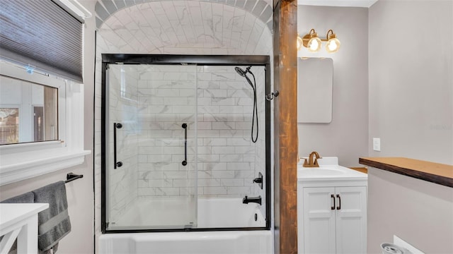 bathroom with vanity and combined bath / shower with glass door