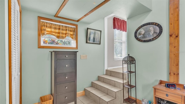 staircase featuring tile patterned flooring