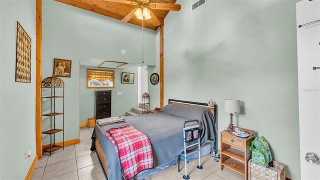 bedroom with a high ceiling, light tile patterned floors, wooden ceiling, and ceiling fan