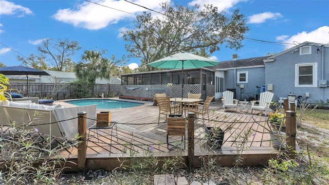 view of pool featuring a sunroom and a deck