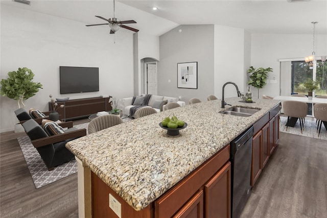 kitchen with black dishwasher, an island with sink, vaulted ceiling, and sink