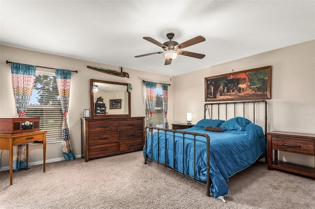 bedroom featuring ceiling fan and light carpet