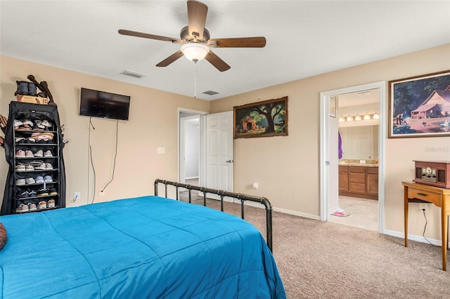 bedroom featuring carpet flooring, ensuite bathroom, and ceiling fan