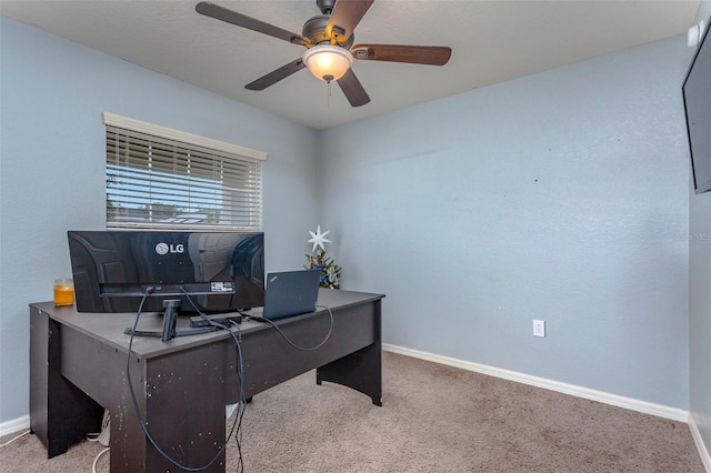 office space with ceiling fan and light carpet