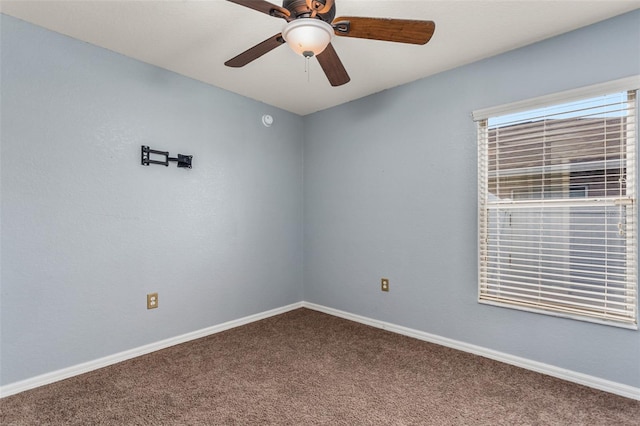 carpeted spare room featuring ceiling fan