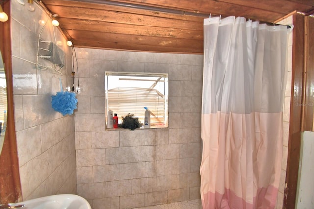 bathroom with wood ceiling, tile walls, and walk in shower