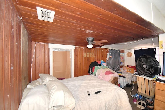 bedroom featuring wood walls and ceiling fan