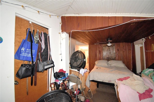 bedroom featuring wood walls