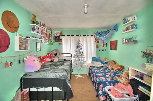 carpeted bedroom featuring a textured ceiling