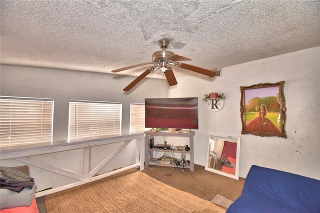 bedroom with carpet flooring, ceiling fan, and a textured ceiling