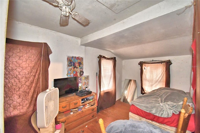 bedroom with ceiling fan, wood-type flooring, and lofted ceiling