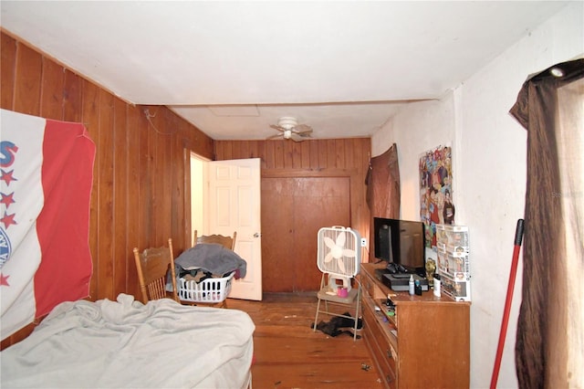 bedroom with wood walls and wood-type flooring