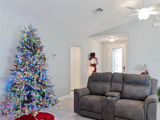 living room featuring ceiling fan and lofted ceiling