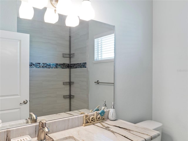 bathroom with vanity and a tile shower