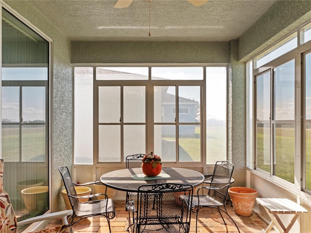 sunroom / solarium with a wealth of natural light and ceiling fan