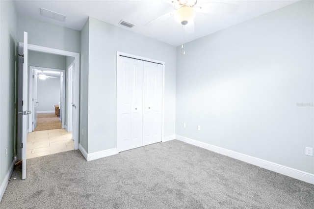 unfurnished bedroom featuring carpet floors, baseboards, visible vents, and a closet