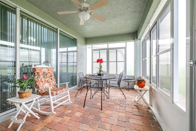 sunroom / solarium with a ceiling fan