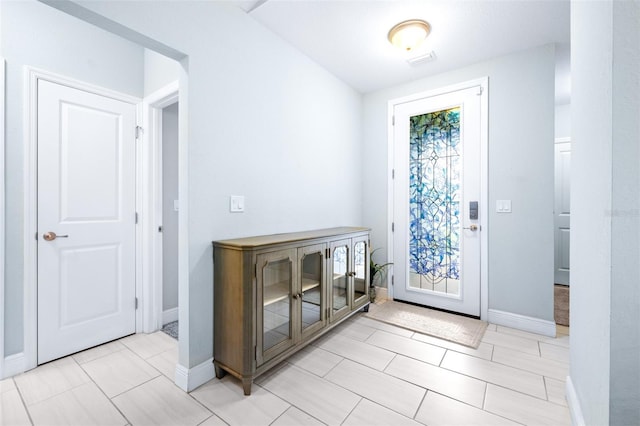 doorway to outside with baseboards