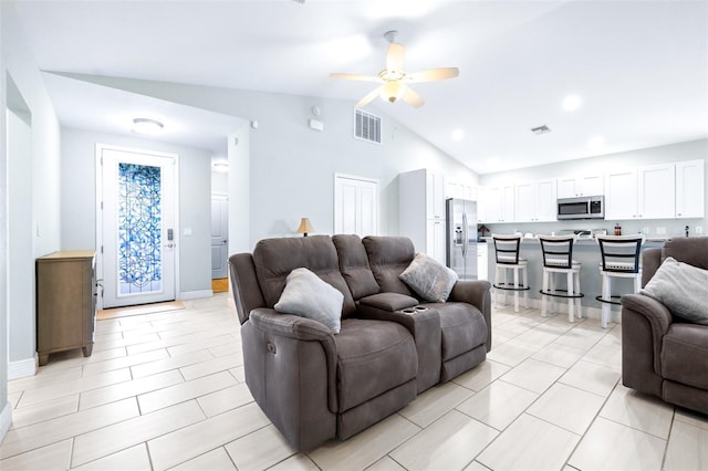 living area featuring baseboards, visible vents, vaulted ceiling, and a ceiling fan