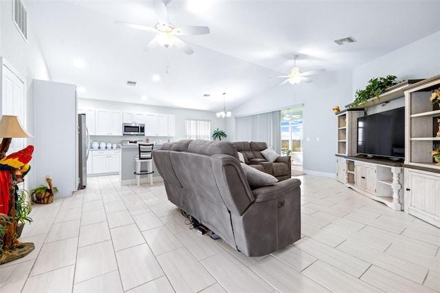 living area featuring lofted ceiling, visible vents, and ceiling fan with notable chandelier