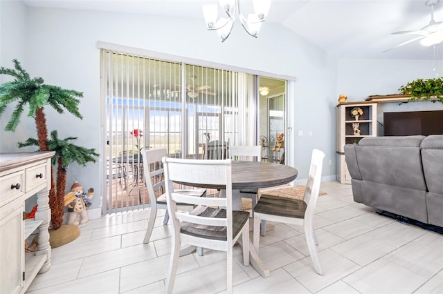 dining room with lofted ceiling, plenty of natural light, baseboards, and ceiling fan with notable chandelier