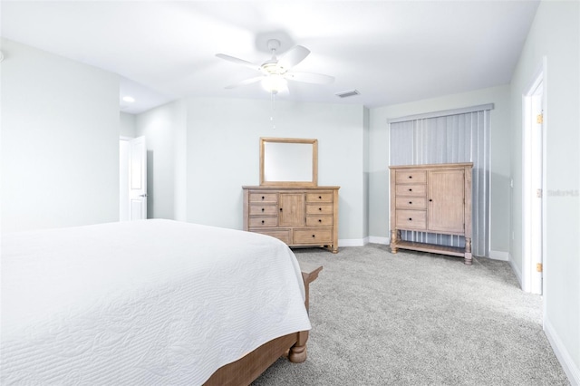 bedroom featuring a ceiling fan, visible vents, light carpet, and baseboards