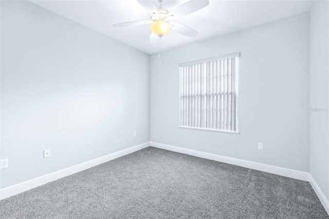 empty room featuring a ceiling fan, baseboards, and carpet flooring