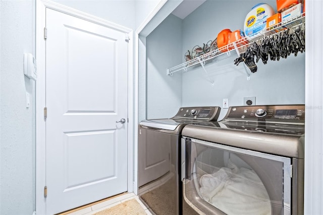 laundry room with laundry area, tile patterned flooring, and washer and dryer