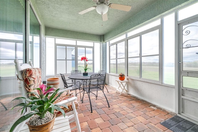 sunroom / solarium with a ceiling fan