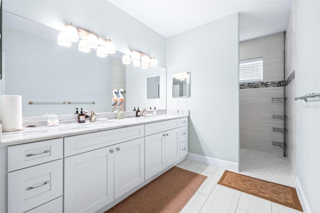 full bath with double vanity, tile patterned flooring, walk in shower, and a sink