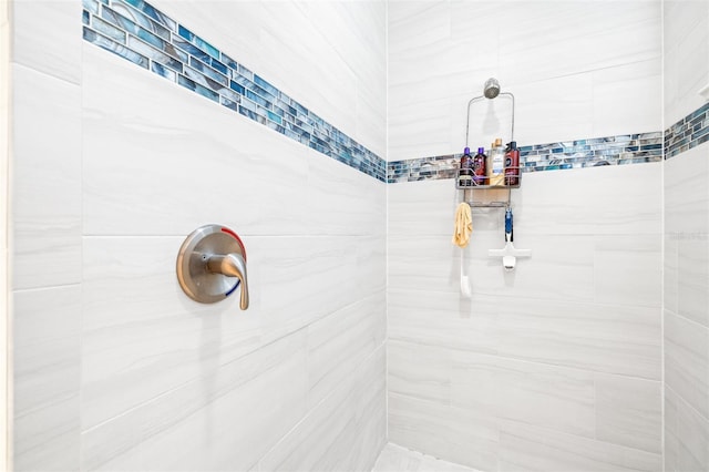 full bath with a tile shower