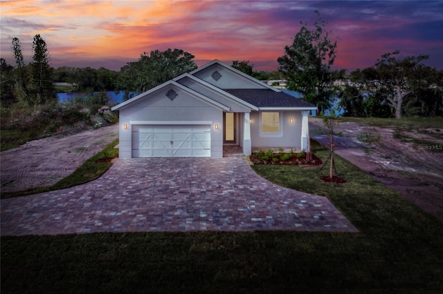 view of front facade featuring a water view and a garage