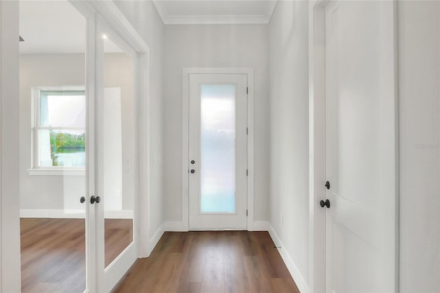 entryway with hardwood / wood-style flooring and crown molding