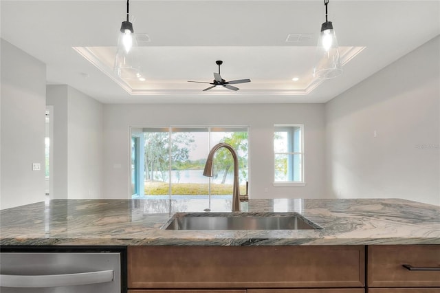 kitchen with light stone countertops, a raised ceiling, ceiling fan, sink, and dishwasher