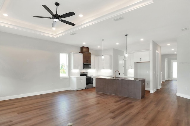 kitchen with sink, hanging light fixtures, an island with sink, white cabinets, and appliances with stainless steel finishes