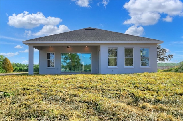 rear view of house with ceiling fan