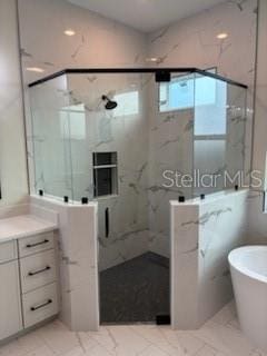 bathroom with separate shower and tub and vanity