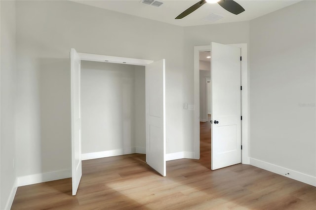 unfurnished bedroom with ceiling fan, a closet, and light hardwood / wood-style floors