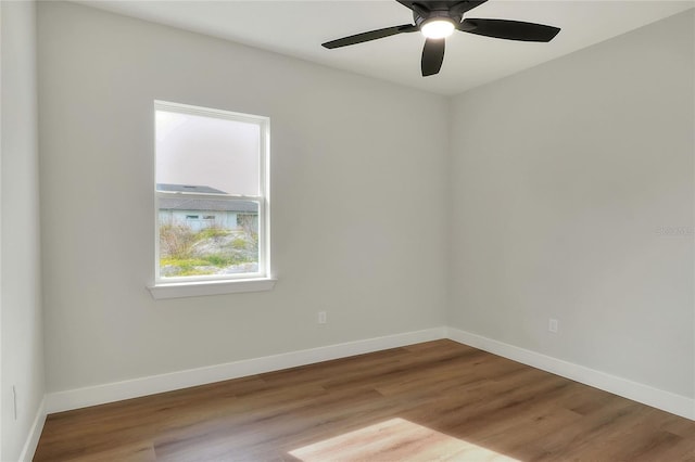 spare room with ceiling fan and light wood-type flooring