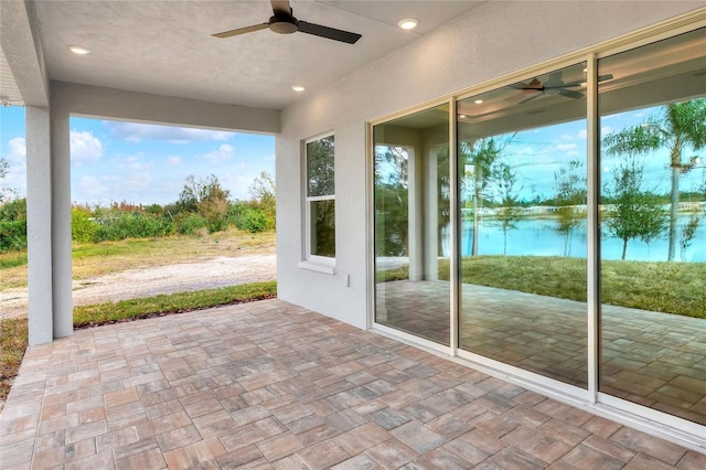 unfurnished sunroom featuring a water view