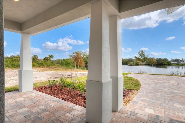 view of patio with a water view