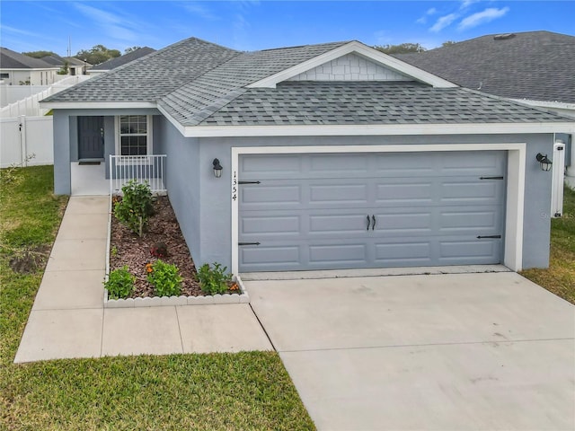 single story home featuring driveway, a shingled roof, an attached garage, and stucco siding