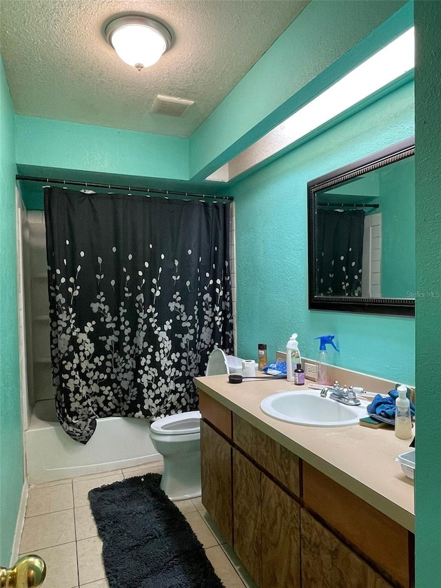 full bathroom with shower / bathtub combination with curtain, tile patterned floors, a textured ceiling, toilet, and vanity